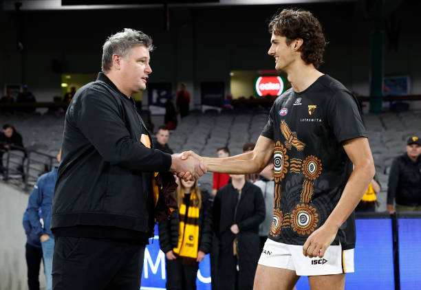 Robert Campbell presents Max Ramsden of the Hawks with his first jumper during the 2023 AFL Round 07 match between the Western Bulldogs and the...