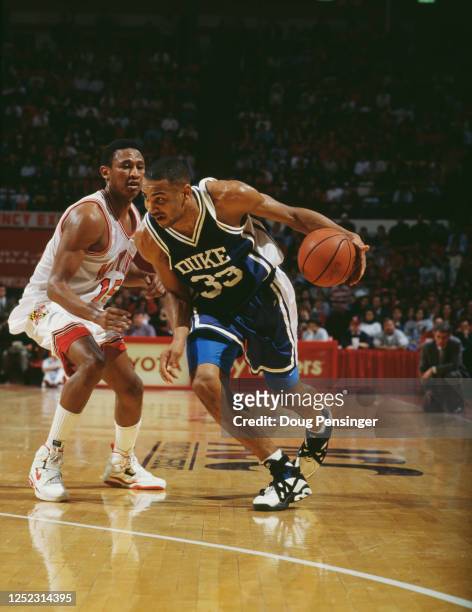 Grant Hill, Forward for the Duke University Blue Devils dribbles the ball down court past Johnny Rhodes of the University of Maryland Terrapins...