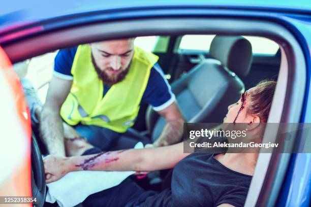 male helping female hurt in traffic accident - teen cpr stock pictures, royalty-free photos & images