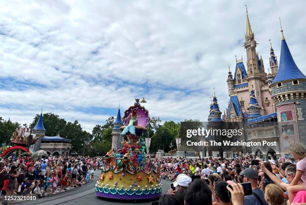 The Disney character Ariel from the movie The Little Mermaid waves to the crowd gathered to watch the character parade at Walt Disney World in...