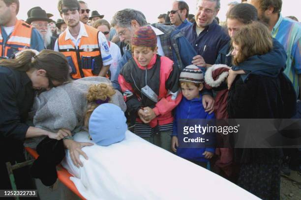 The family of Yaakov Mandell mourn over the 14-year-old boy's shrouded body during prayers before his funeral 09 May 2001 near the Gush Etzion...