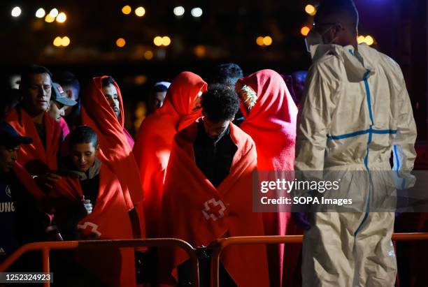 Migrants are seen waiting to disembark from a Spanish rescue boat after they arrive at Port of Malaga. Salvamento Maritimo rescued a dinghy with...