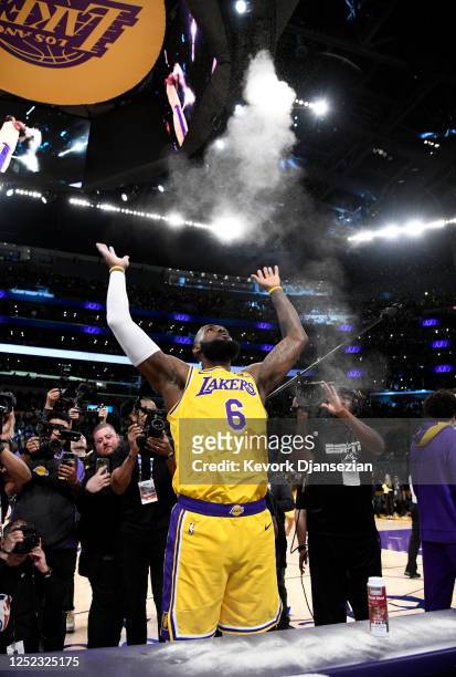 LeBron James of the Los Angeles Lakers throws Rosin Blend powder in the air before the start of the game against Memphis Grizzlies in Round 1 Game 6...