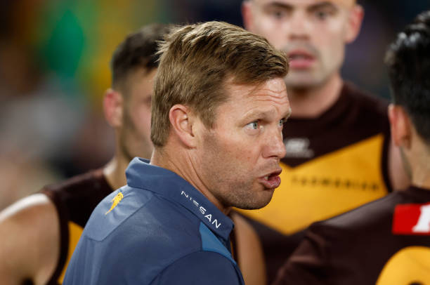 Sam Mitchell, Senior Coach of the Hawks addresses his players during the 2023 AFL Round 07 match between the Western Bulldogs and the Hawthorn Hawks...