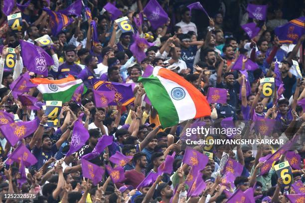 Fans cheer for Kolkata Knight Riders' team during the Indian Premier League Twenty20 cricket match between Kolkata Knight Riders and Gujarat Titans...