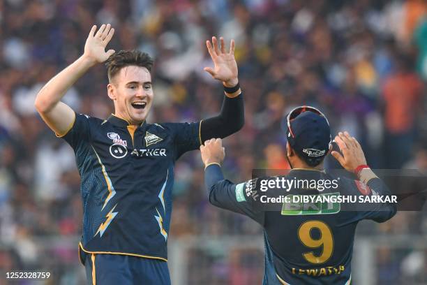 Gujarat Titans' Josh Little celebrates with his teammate after taking the wicket of Kolkata Knight Riders' Nitish Rana during the Indian Premier...