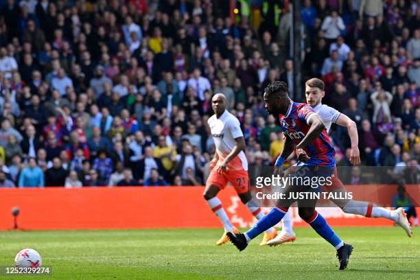 Crystal Palace's German midfielder Jeffrey Schlupp shoots to score their third goal during the English Premier League football match between Crystal...