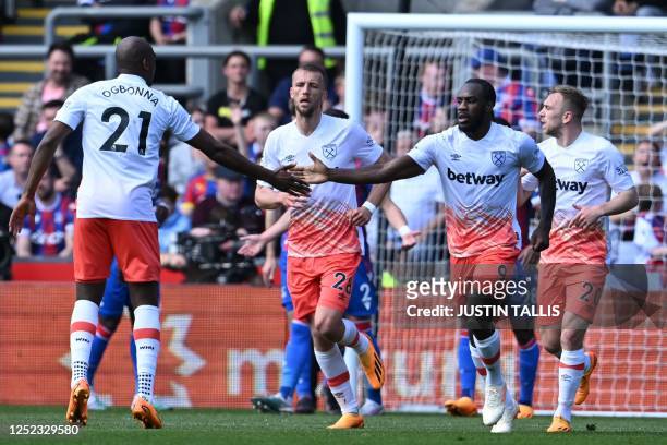 West Ham United's English midfielder Michail Antonio celebrates with teammates after scoring their second goal during the English Premier League...