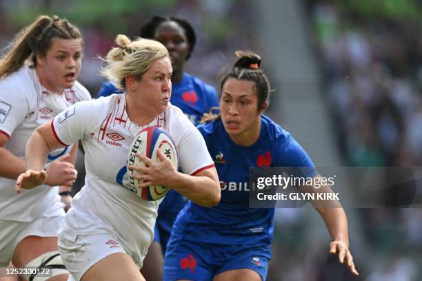 England's flanker Marlie Packer runs with the ball to score a try during the Six Nations international women's rugby union match between England and...