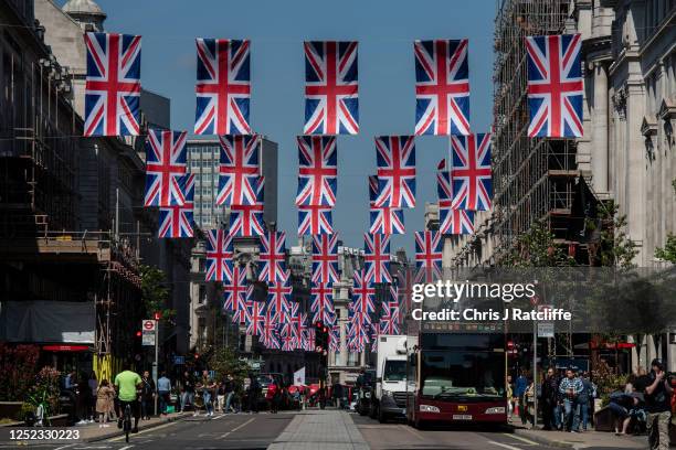 Bunting for the coronation of King Charles III adorns Regent street on April 29, 2023 in London, England. The Coronation of King Charles III and The...