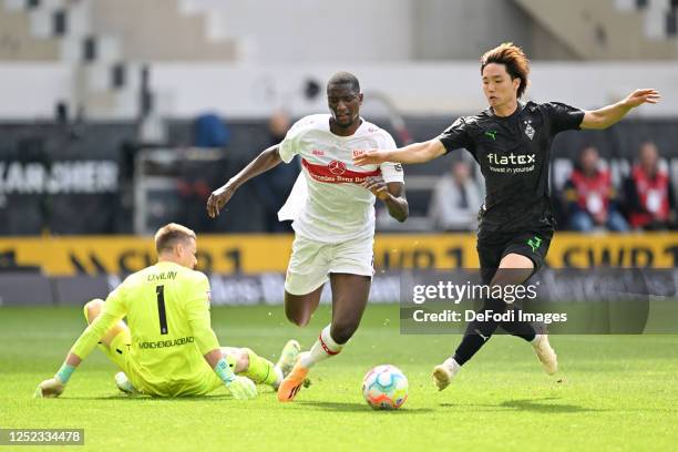 Goalkeeper Jonas Omlin of Borussia Moenchengladbach, Serhou Guirassy of VfB Stuttgart and Ko Itakura of Borussia Moenchengladbach battle for the ball...