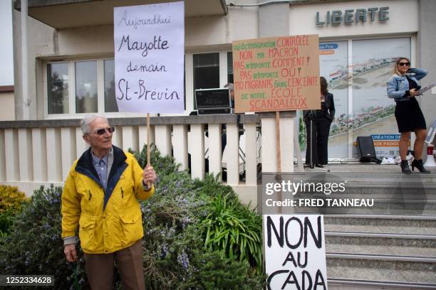 Demonstrator, holding a placard reading "Today Mayotte, Tomorrow Saint-Brevin", takes part in a protest against the project of a new CADA, a...