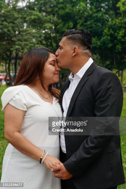 Married couple enjoys in a park at the end of the a civil ceremony of Collective Weddings of 24 couples, organized by the Municipality of San...