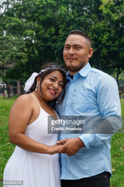 Married couple enjoys in a park at the end of the a civil ceremony of Collective Weddings of 24 couples, organized by the Municipality of San...