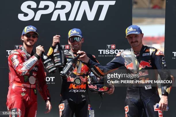 Second-placed Ducati Italian rider Francesco Bagnaia, first-placed KTM South African rider Brad Binder and third-placed KTM Australian rider Jack...