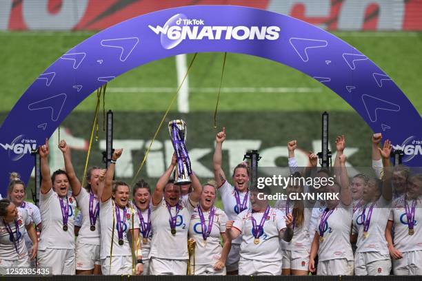 England's teammates celebrate with the trophy after winning the Women's Six Nations Grand Slam at the end of the Six Nations international women's...