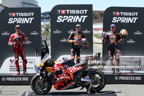 Second-placed Ducati Italian rider Francesco Bagnaia, first-placed KTM South African rider Brad Binder and third-placed KTM Australian rider Jack...