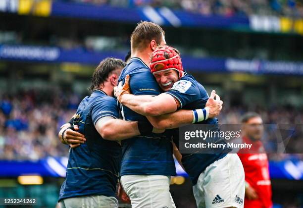 Dublin , Ireland - 29 April 2023; Jason Jenkins of Leinster, centre, celebrates with teammates Andrew Porter and Josh van der Flier after scoring his...