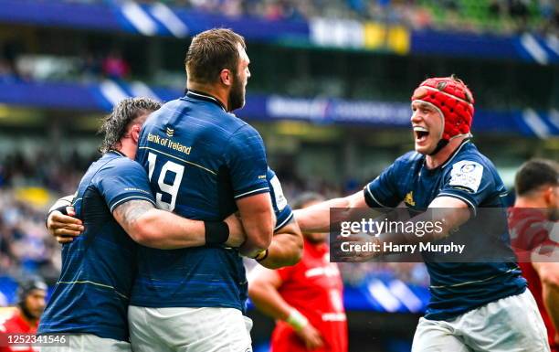 Dublin , Ireland - 29 April 2023; Jason Jenkins of Leinster, centre, celebrates with teammates Andrew Porter and Josh van der Flier after scoring his...