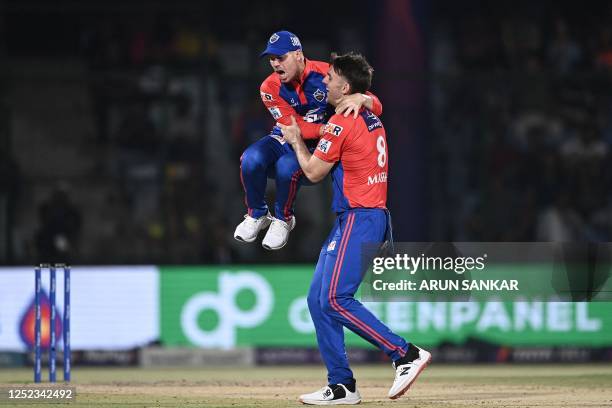 Delhi Capitals' Mitchell Marsh celebrates with David Warner after taking the wicket of Sunrisers Hyderabad's Harry Brook during the Indian Premier...