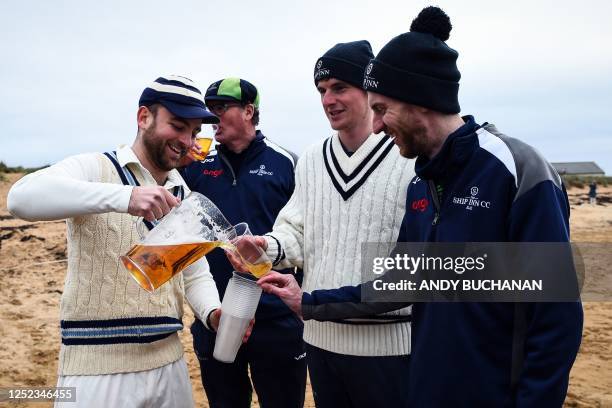 Players from the Ship Inn CC and the Old Seagullians, teams made up of current and former students from St Andrews University, have a drink after...