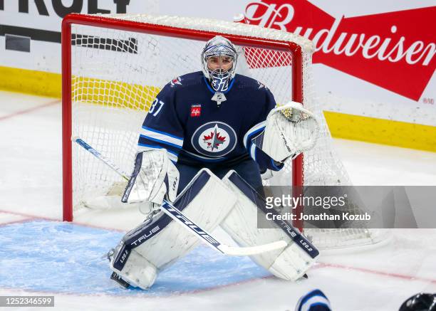 Goaltender Connor Hellebuyck of the Winnipeg Jets guards the net during first period action against the Vegas Golden Knights in Game Three of the...