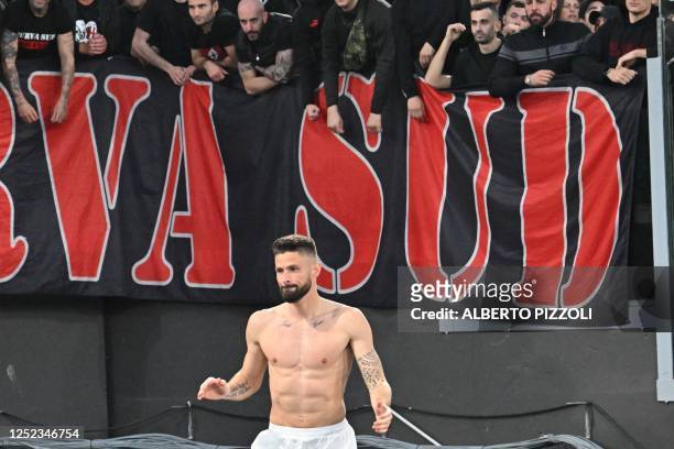 Milan's French forward Olivier Giroud salutes the supporters at the end of the Italian Serie A football match between AS Rome and AC Milan at the...