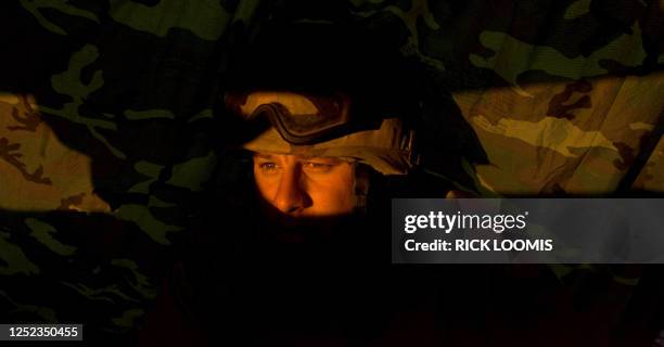 Marine Lt. Ronald Reed of Reston, Va. Sits inside his fighting position on the perimeter defense position around Afghanistan's Kandahar International...