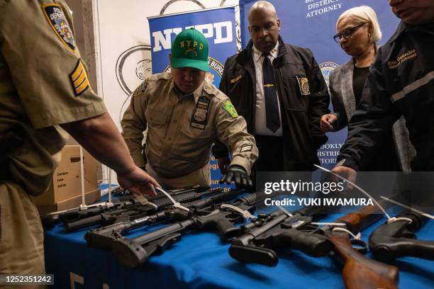 Police officers display handguns and firearms during a statewide gun buyback event held by the office of the New York State Attorney General, in the...