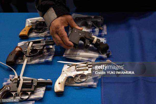 Kings County District Attorney Eric Gonzalez holds a 3D printed ghost gun during a statewide gun buyback event held by the office of the New York...