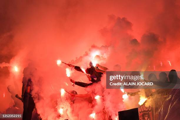 Toulouse's supporter lights flares during the French Cup final football match between Nantes and Toulouse at the Stade de France, in Saint-Denis, on...
