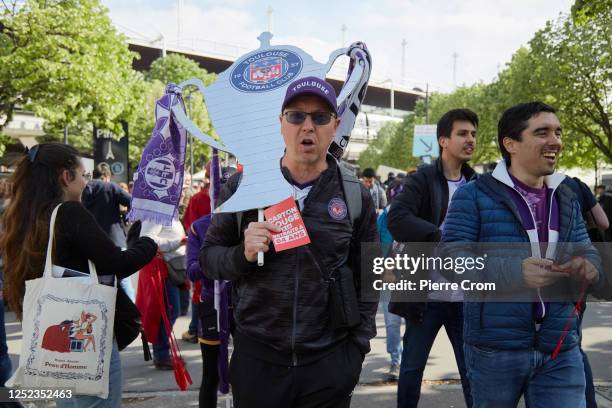 Members of worker unions distribute red whistles and red cards to football supporters attending the final of the French Cup at Stade de France on...