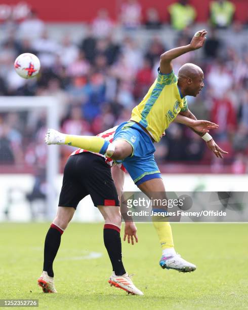 Ben Mee of Brentford and Andre Ayew of Nottingham Forest during the Premier League match between Brentford FC and Nottingham Forest at Brentford...