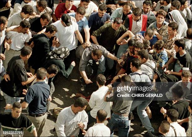 Palestinians lynch an undercover Israeli soldier in the West bank town of Ramallah 12 October 2000. Israeli missiles hit Palestinian security and...