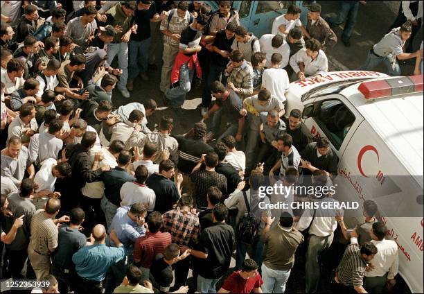 Palestinians lynch an undercover Israeli soldier in the West bank town of Ramallah 12 October 2000. Israeli missiles hit Palestinian security and...