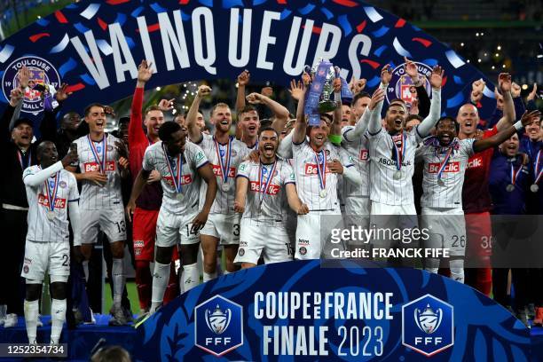 Toulouse's Belgian midfielder Brecht Dejaegere holds the trophy after winning the French Cup final football match between Nantes and Toulouse at the...