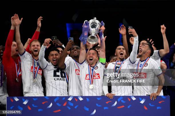 Toulouse's Belgian midfielder Brecht Dejaegere holds the trophy after winning the French Cup final football match between Nantes and Toulouse at the...