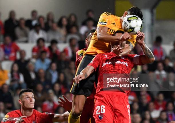 Benfica's Croatian forward Petar Musa heads the ball over Gil Vicente's Portuguese defender Ruben during the Portuguese league football match between...