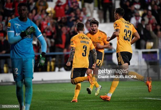 Benfica's Spanish defender Alex Grimaldo celebrates with teammates after scoring a goal during the Portuguese league football match between Gil...