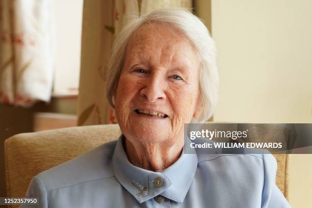 Joyce Lewis poses for a photo at her home in Bidford-on-Avon, central England, on April 25, 2023. - Joyce Lewis has just turned 90, a little over a...