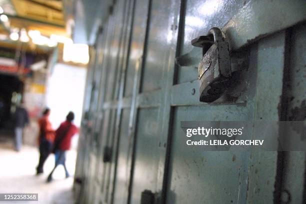 Palestinian women walk through the Old City of Jerusalem 31 March 2002 where shops were locked up or doors merely ajar in a show of support for...