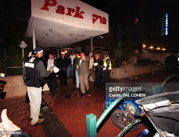 Israeli police gather in front of the Park Hotel 27 March 2002 in the northern Israeli town of Netanya following a suicide bombing in the hotel...