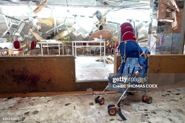 Stroller sits abandoned inside the destroyed Park Hotel in Netanya 28 March 2002, following a suicide attack late last night that killed 20 people...