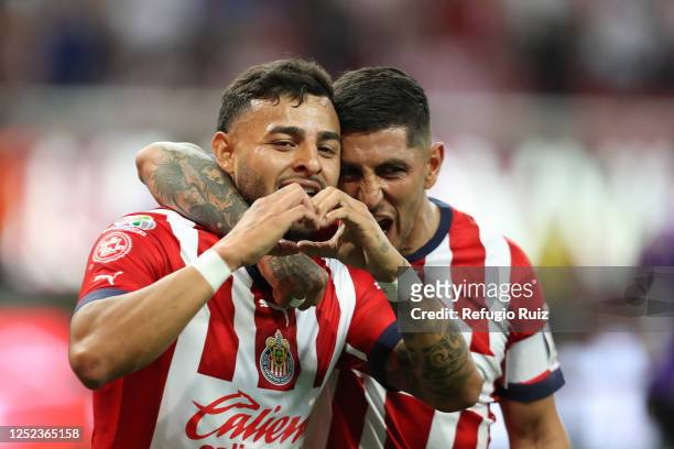 Alexis Vega of Chivas celebrates with teammate Victor Guzman after scoring the team's second goalduring the 17th round match between Chivas and...