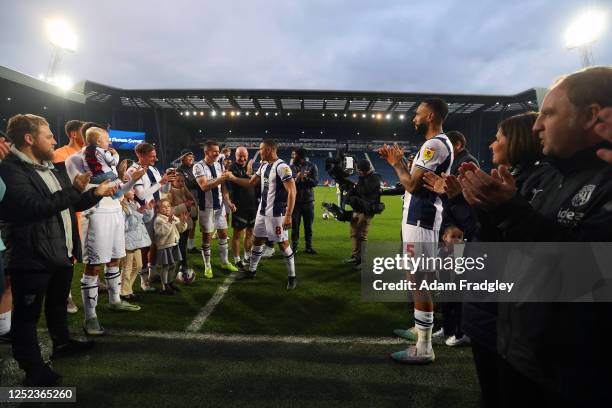 Jed Wallace of West Bromwich Albion shakes hands with Jake Livermore of West Bromwich Albion as West Bromwich Albion players and staff form a guard...