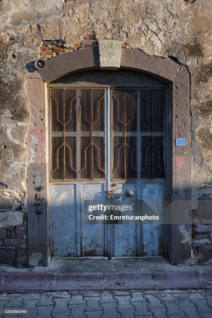 Old door of an abandoned olive oil factory in Ildir,Aegean Turkey.