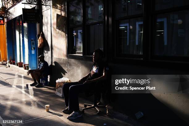 Man sits outside of a closed music venue in Manhattan as the city enters Phase 2 of re-opening following restrictions imposed to curb the coronavirus...