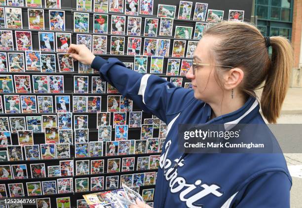 Fan trades a baseball card on the trade wall during the 2023 Topps Truck Tour promotion outside of Comerica Park during game one of a doubleheader...