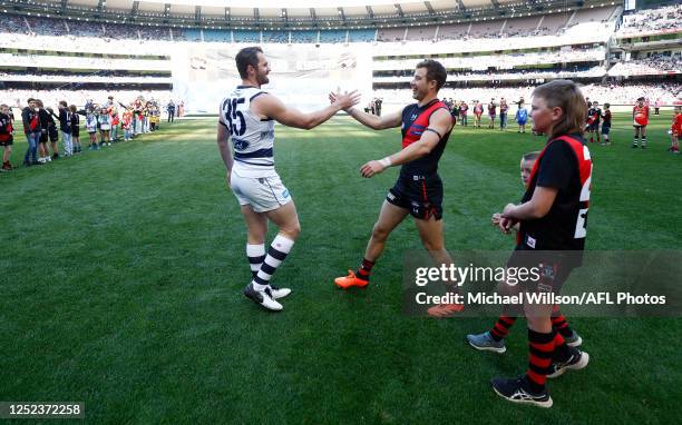 Patrick Dangerfield of the Cats and Zach Merrett of the Bombers shake hands during the 2023 AFL Round 07 match between the Essendon Bombers and the...