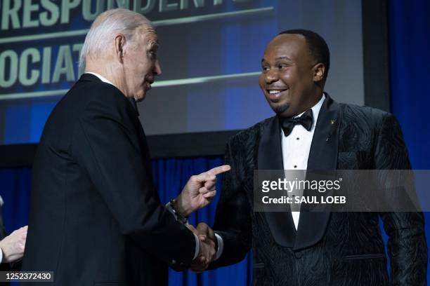Comedian Roy Wood Jr shakes hands with US President Joe Biden during the White House Correspondents' Association dinner at the Washington Hilton in...